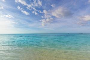 Nature landscape view of beautiful tropical beach sea in sunny day. Summer seascape beautiful waves, blue sea water. amazing tropical nature background. Beautiful bright sea waves splashing and beach photo