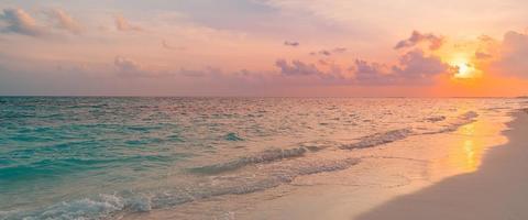 Closeup sea sand beach. Panoramic beach landscape. Inspire tropical beach seascape horizon. Golden dream sunset sky, calm tranquil relaxing sunlight summer shore waves. Vacation travel holiday banner photo