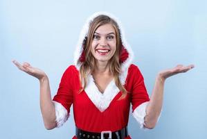 closeup of caucasian happy woman wearing santa clothes looking to camera photo