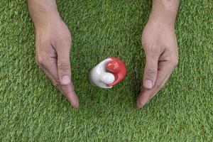 Top view mock up couple hugging on grass floor with hand guard. Valentine day concept photo