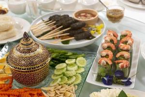 Porcelain cups, boiled eggs, carrots, ginger, along with salad rolls. Traditional Thai food. photo