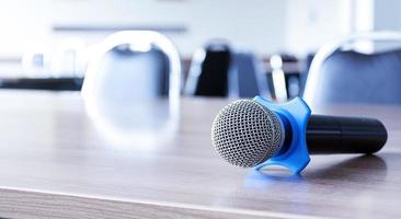 Microphone on table in seminar room and copy space photo