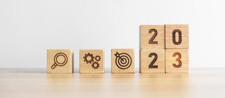 2023 wood block with business goal, plan. Action strategy, target, mission, teamwork, idea and New Year start concept photo