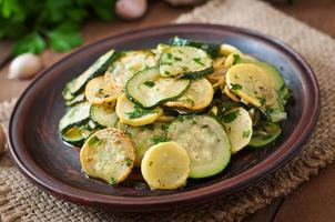 Warm salad with young zucchini with garlic and herbs. photo