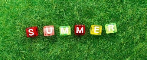 word summer on green grass background. lawn desktop nature pattern. banner photo