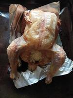 Baked chicken in the oven on foil photo