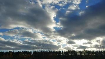 Multi-colored clouds fly over the village video