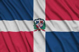 Dominican Republic flag is depicted on a sports cloth fabric with many folds. Sport team banner photo