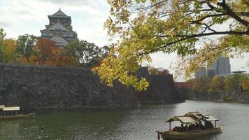2019-11-25 Osaka, Japan. touristic boats with tourists along the moat of Osaka Castle one of best activities you can experience around Osaka Castle area, one of most famous landmarks of Japan video