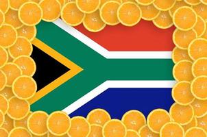 South Africa flag in fresh citrus fruit slices frame photo