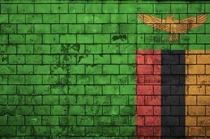 Zambia flag is painted onto an old brick wall photo