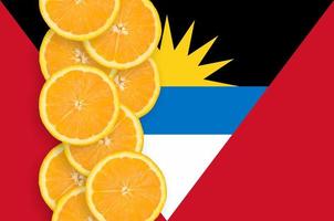 Antigua and Barbuda flag and citrus fruit slices vertical row photo