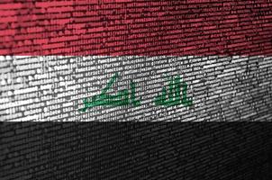 Iraq flag is depicted on the screen with the program code. The concept of modern technology and site development photo