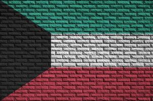 Kuwait flag is painted onto an old brick wall photo