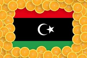 Libya flag in fresh citrus fruit slices frame photo