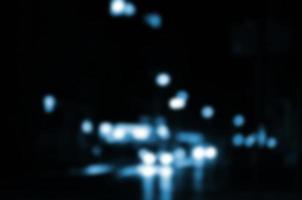 Blurred night scene of traffic on the roadway. Defocused image of cars traveling with luminous headlights. Bokeh Art photo