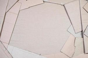 Background image with a lot of beige cardboard paper, which is used to make boxes for the transport of home appliances and postal parcels. Carton texture photo