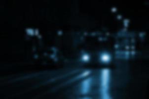 Blurred night scene of traffic on the roadway. Defocused image of cars traveling with luminous headlights. Bokeh Art photo