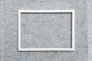 Rectangular blank white frame on gray felt. Abstract background. Copy space. Top view. photo