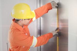 Worker Engineer uses a meter tape to measure values according to the laser level photo