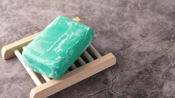 Foamy green soap bar on little wood stand video