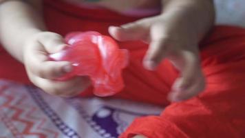 Kid playing with red slime video
