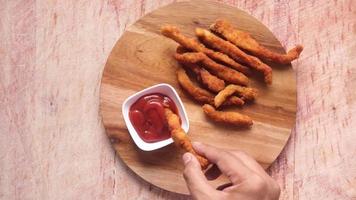 Dipping chicken fingers in ketchup video