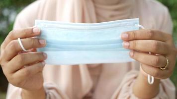 Woman puts on disposable surgical face mask video