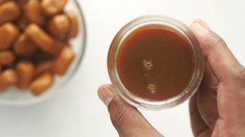 A cup of caramel sauce, close up video