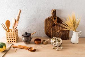 a set of various kitchen utensils of a country house, a cottage on a wooden countertop. interior items. ecologically clean kitchen. photo