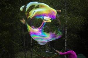 Big bubble on street. Thin soap film. Soap balloon. photo