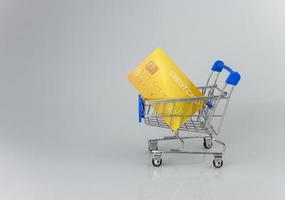 Shopping car and mockup credit card  on light and shadow background. shopping online concept. photo