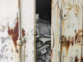 Used sacks in old metal cargo containers photo
