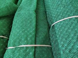 Rolls of green mesh for construction and agriculture, artificial net fencing photo