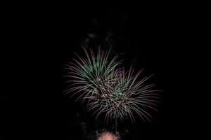 fireworks on the river in the dark sky photo