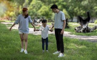 A happy Asian family event featuring the parents and children having fun together on vacation. photo