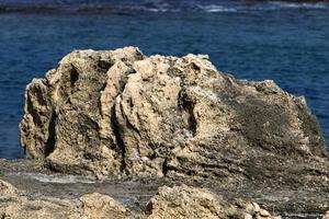 Rocks on the shores of the Mediterranean Sea in northern Israel. photo