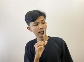 man cutting his own beard using scissors by himself photo