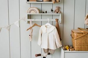 Toys and children's clothes in the children's room in a cozy Scandinavian style photo
