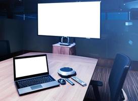 Television and laptop with mockup white screen on display in meeting room photo