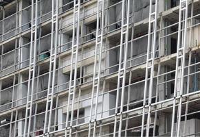 Building construction site with steel scaffold photo