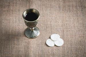 Concept of Eucharist or holy communion of Christianity. Eucharist is sacrament instituted by Jesus. during last supper with disciples. Bread and wine is body and blood of Jesus Christ of Christians. photo