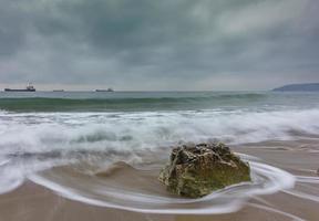 Beauty cloudy, long exposure seascape with slow shutter and waves flowing out. photo