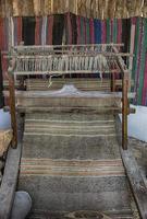 A traditional vintage bulgarian weaving loom with rug photo