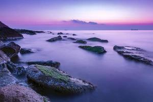 tranquility and calm long exposure rocky coast before sunrise . photo