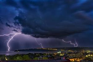 Exciting powerful lightning over the sea, zipper and thunderstorm, Varna. Bulgaria photo