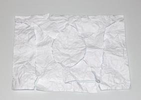 torn and assembled white wrinkled paper photo