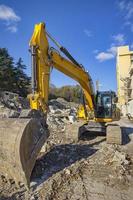 Yellow excavator with shovel  at construction site . photo