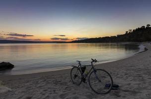 view of bicycle on the shore amid beautiful sunset photo