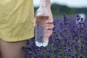 Hand holding a bottle of water photo